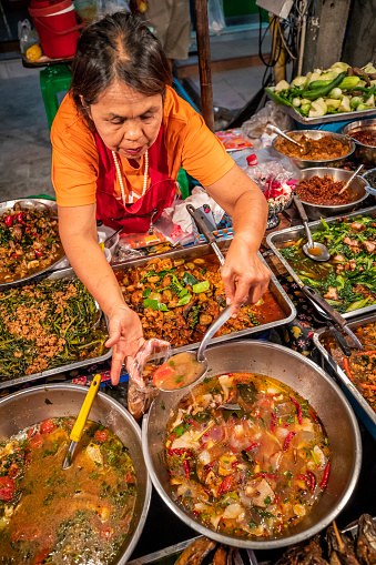 Thai street food seller at the night market in Chiang Mai, Northern Thailand