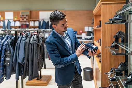 Portrait of a man shopping at a clothing store. sale, shopping, fashion, style and people concept