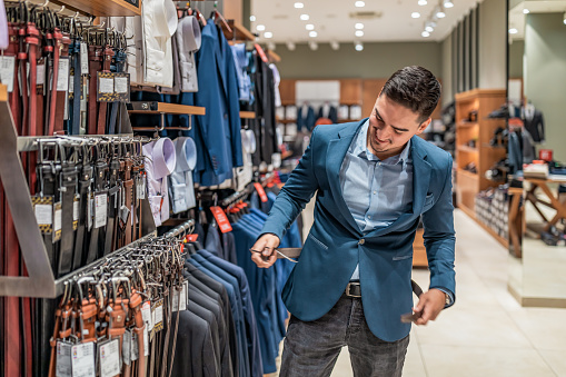 Portrait of a man shopping at a clothing store. sale, shopping, fashion, style and people concept