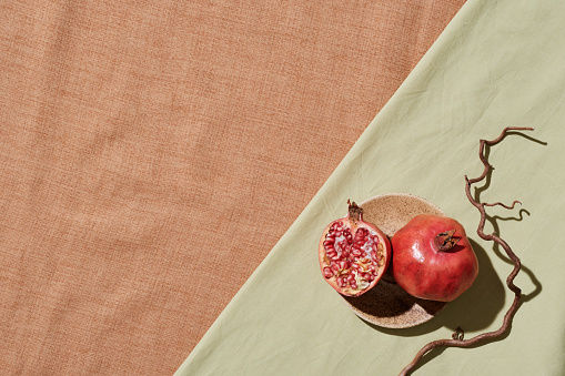 Pomegranate on light green tablecloth