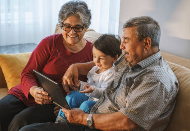 istock Grandparents with grandson at home using digital tablet, 4K Video footage 1346244632