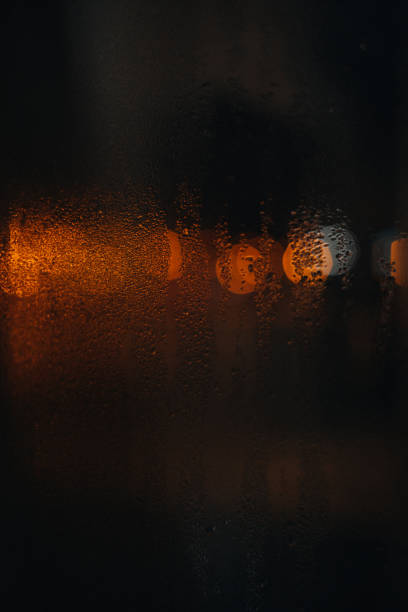 istock Wet glass after the rain with blurry lights 1346246910