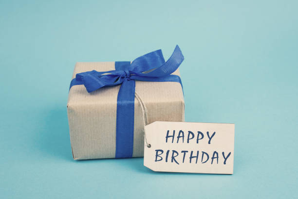 Gift boxes in different sizes and colors in front of a dark blue background, copy space