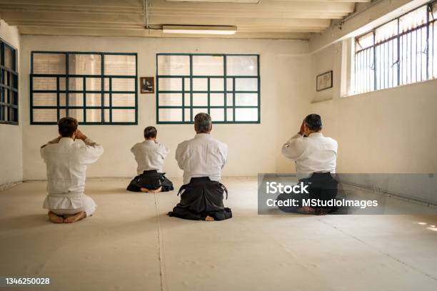 Four People Meditating Before Aikido Training Stock Photo - Download Image Now - Martial Arts, Karate, Indoors
