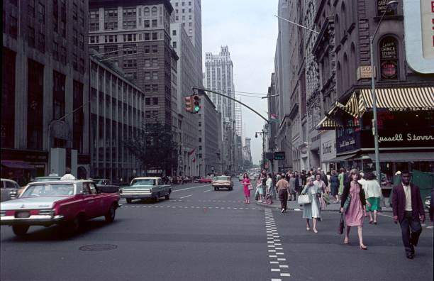 New York City, NY, USA, 1964. Street scene with New Yorkers on Fifth Avenue in Midtown Manhattan. Also: buildings, shops and cars.