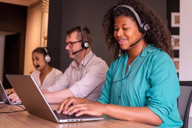 istock Two women and a man working in customer service 1346251287