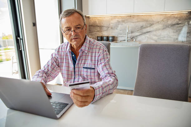 istock Senior Man Online Banking 1346252172