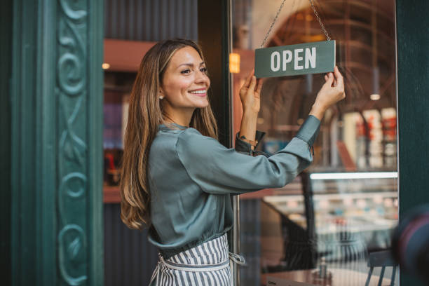 Small business owner Young woman owner of ice cream shop in town. She is opening her store and waiting for costumers. new business stock pictures, royalty-free photos & images