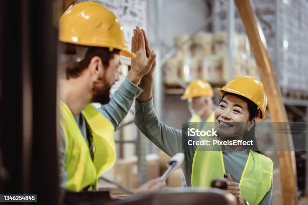 We Really Do Achieve More When We Stand Together Stock Photo - Download Image Now - Warehouse, Employee, High-Five