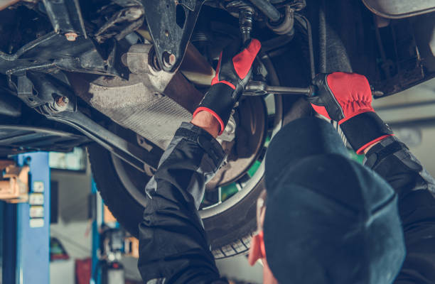 istock Automotive Caucasian Mechanic Working Under a Vehicle 1346257916