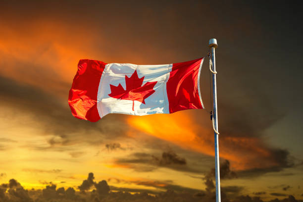 istock Canadian flag against blue sky 1346262182