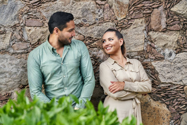 Young latin male and female couple looking at each other in love between 25 and 35 years old stock photo