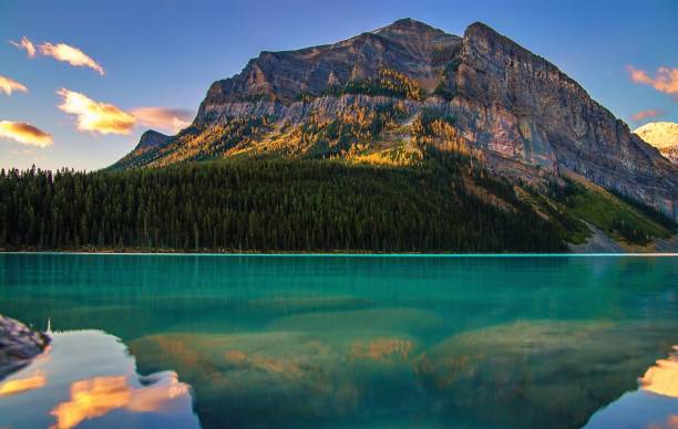 istock Sunrise Over Mountains At Lake Louise 1346264770