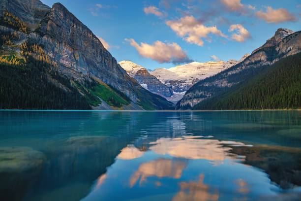 istock Sunrise Clouds Reflecting On Lake Louise 1346264785