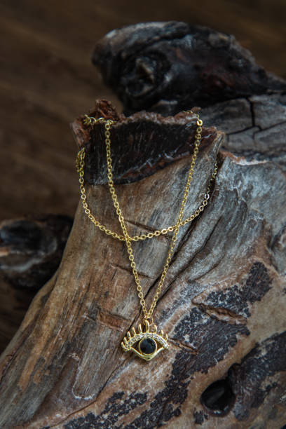 istock Golden necklace presented on old wooden background. 1346266008