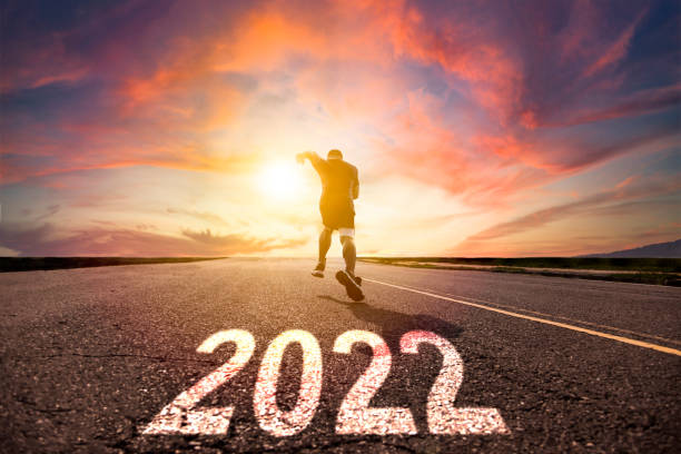 istock Man running and sprinting on road with 2022 new year concept 1346268810