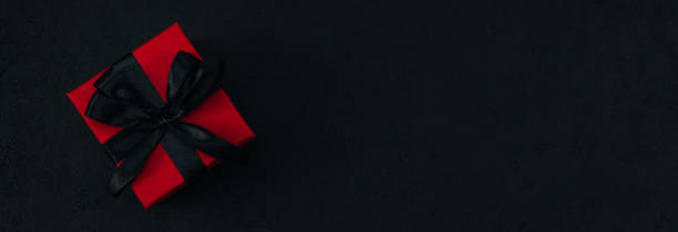 istock Red gift box with black satin ribbon 1346269007