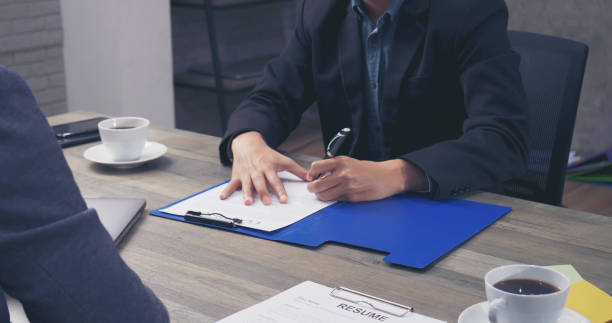 istock Two Businessman signing contract document start business agreement dealing teamwork. Close up hand young man colleagues  meeting mergers and acquisitions business. Partners Signed document at office. 1346275367