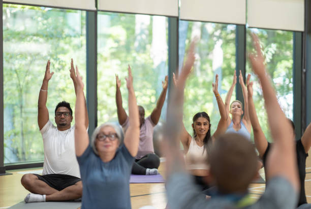 istock Male yoga instructor leads class 1346275786