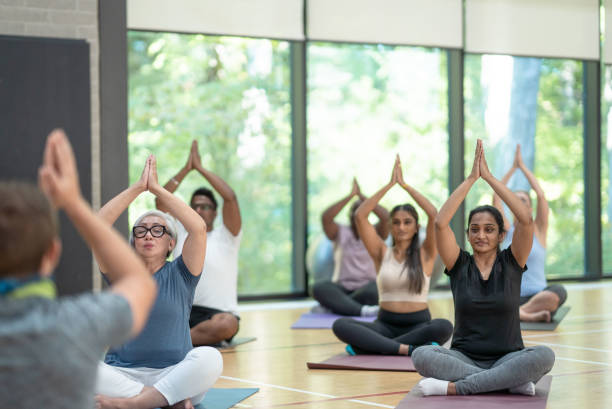 istock Male yoga instructor leads class 1346275796