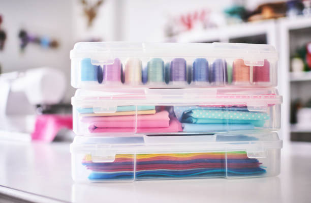 istock Craft Supplies Stored in Plastic Container on a Sewing. Table in a Craft Room 1346279143