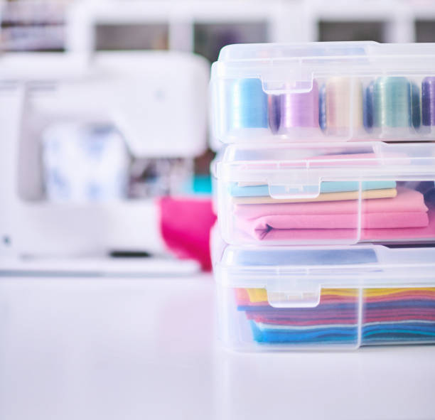 istock Craft Supplies Stored in Plastic Container on a Sewing. Table in a Craft Room 1346279153