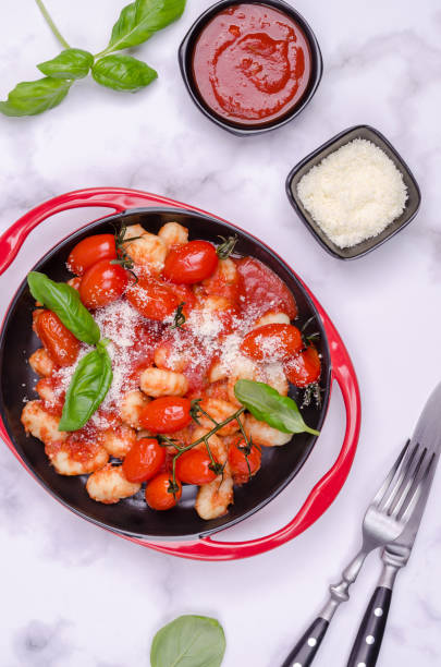 istock Gnocchi with tomatoes, red sauce, cheese and basil leaves 1346281942