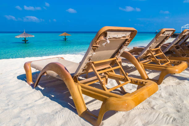 istock Sun bed and parasol at tropical beach 1346282648