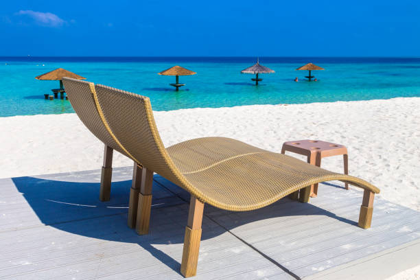 istock Sun bed and parasol at tropical beach 1346282734