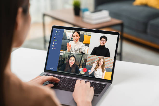 istock woman using laptop on table with making video call meeting to team online and present work projects. Concept working from home. 1346282767