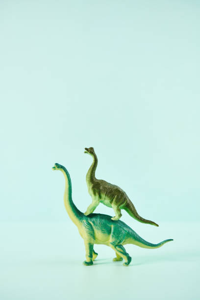 istock Dinosaur Giving a Piggyback Ride to Another Dinosaur 1346285254