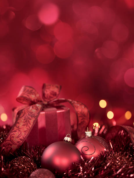istock Christmas Gift and Baubles on a Red Tinsel Background 1346287250