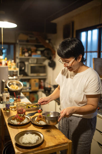 istock Woman preparing dinner for her family in rustic kitchen 1346289758