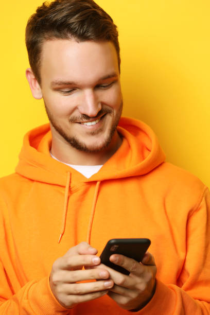 istock young man holding mobile phone and making photo 1346290195