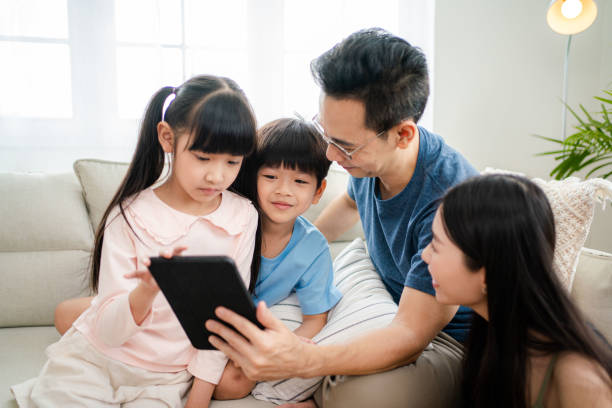 istock Family together using tablet at home. 1346290811