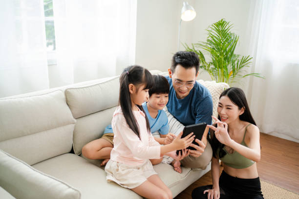 istock Family together using tablet at home. 1346290812