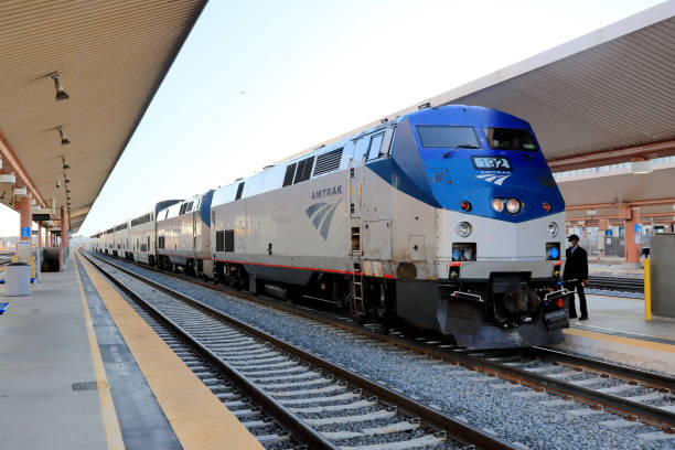 Staff Member preparing for the departure of Amtrak Southwest Chief Train, Los Angeles Union Station Los Angeles, California, USA - October 10, 2021: Staff Member preparing for the departure of Amtrak Southwest Chief Train, Los Angeles Union Station.

The Southwest Chief train is a passenger train operated by Amtrak on a 2,265-mile (3,645 km) route between Los Angeles, California and Chicago, Illinois. Amtrak stock pictures, royalty-free photos & images