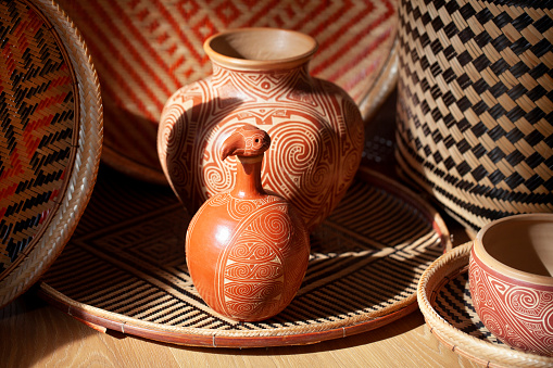 Vases and baskets are handmade and are colored using natural dyes. The designs are ethnic in origin. Handicraft products of Indigenous tribes in Brazil.