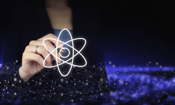 istock Atom molecule abstract. Hand holding digital graphic pen and drawing digital hologram molecule atom sign on city dark blurred background. Atom molecule as concept for science. 1346296810