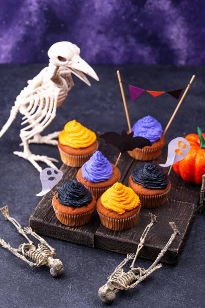 istock Halloween cupcakes with color cream 1346299681