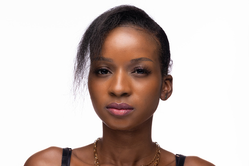 Studio Portrait Of Young African Woman In Black Top On Simple Neutral Background