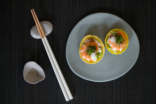 Asian style shrimp tartlets on grey plate with wooden chopsticks