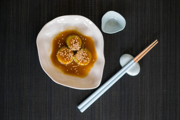 istock Zucchini in sauce with sesame seeds on white plate with chopsticks 1346305957