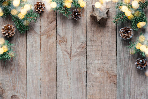 istock Christmas background with fir tree branches, pine cones, and Christmas lights 1346306316