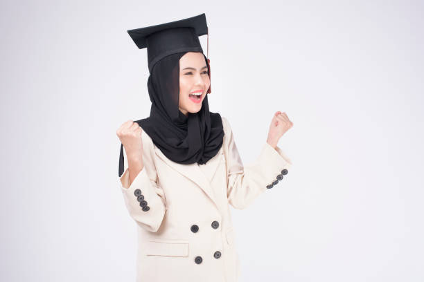 istock Young muslim woman graduated over white background studio. 1346307598