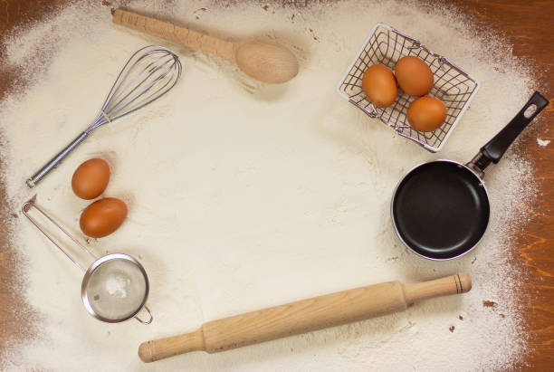 istock frame of kitchen utensils and chicken eggs on a table with flour, place for text, 1346308396