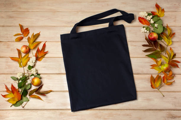 istock Black tote bag mockup with fall leaves and snowberry 1346308639