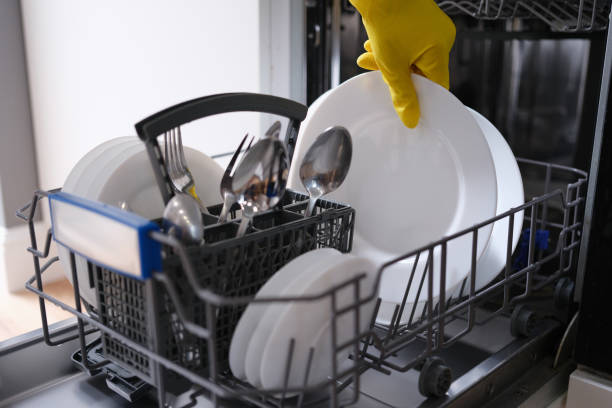 istock Complete dishwasher with clean washed dishes closeup 1346311295