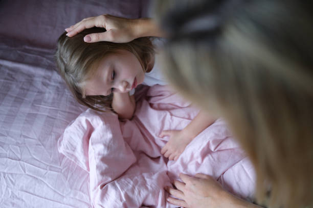 Mom puts sad girl on head before going to bed.