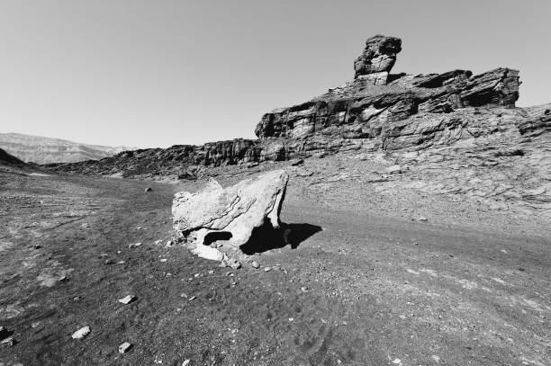 Loneliness and emptiness of the rocky hills of the Negev Desert in Israel. Breathtaking landscape and nature of the Middle East. Black and white photo